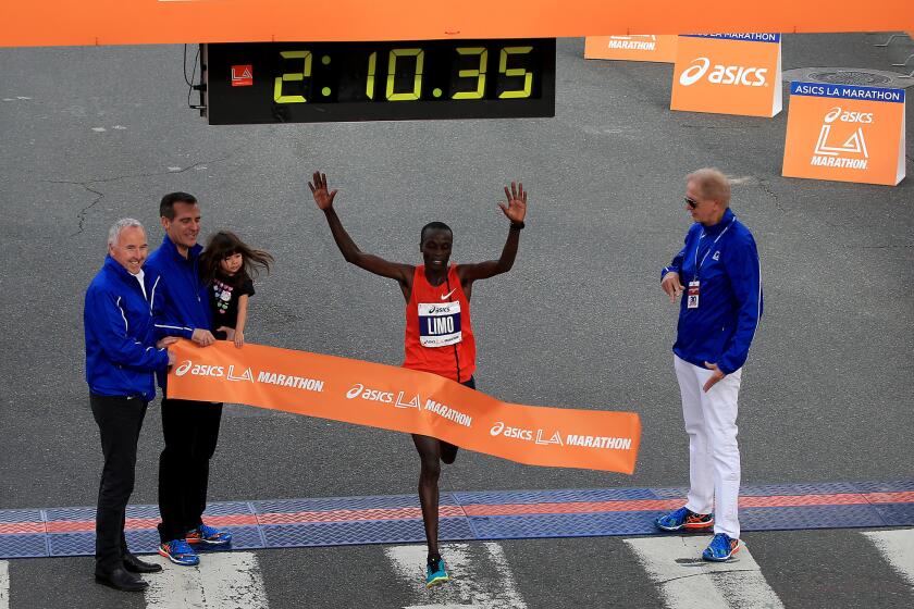 Daniel Limo of Kenya crosses the finish line to win the 30th Los Angeles Marathon.