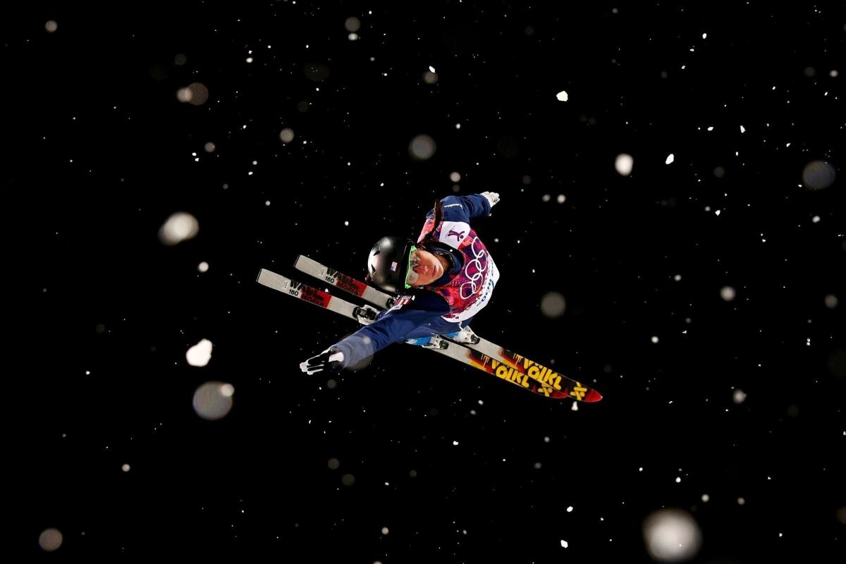 Emily Cook sails through the air during a practice run for the freestyle skiing ladies' aerials finals Friday. Cook did not advance past the first round of the finals.