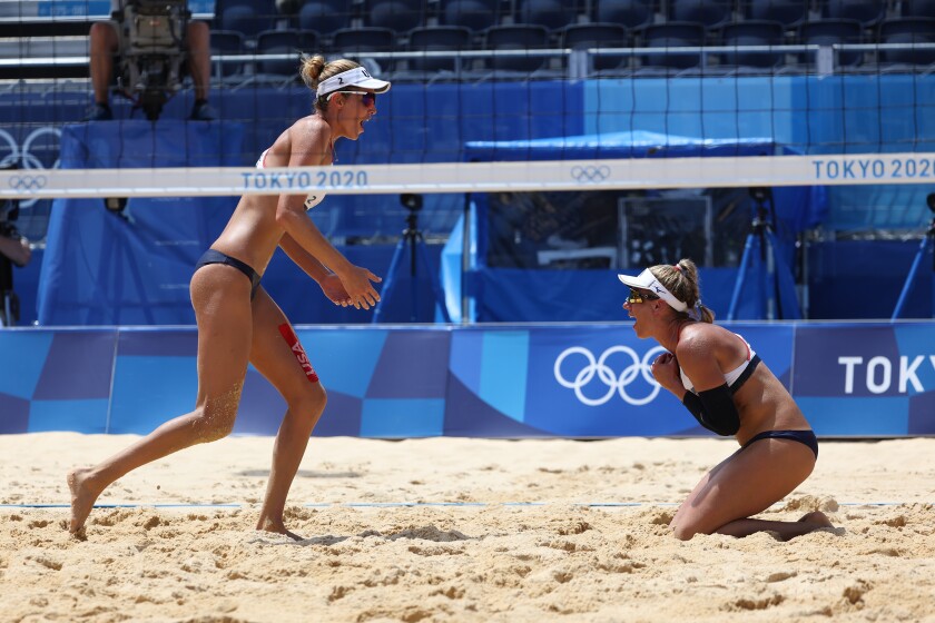 Alix Klineman, left, and April Ross celebrate winning the gold medal at the Tokyo Olympics on Friday.