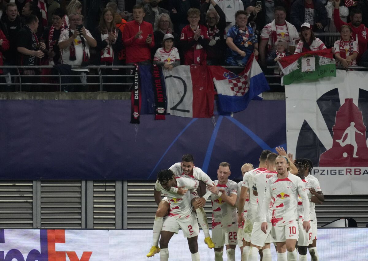 Leipzig's Andre Silva celebrates with teammates after scoring his side's third goal during the Champions League Group F soccer match between RB Leipzig and Celtic, in Leipzig, Germany, Wednesday, Oct. 5, 2022. (AP Photo/Michael Sohn)