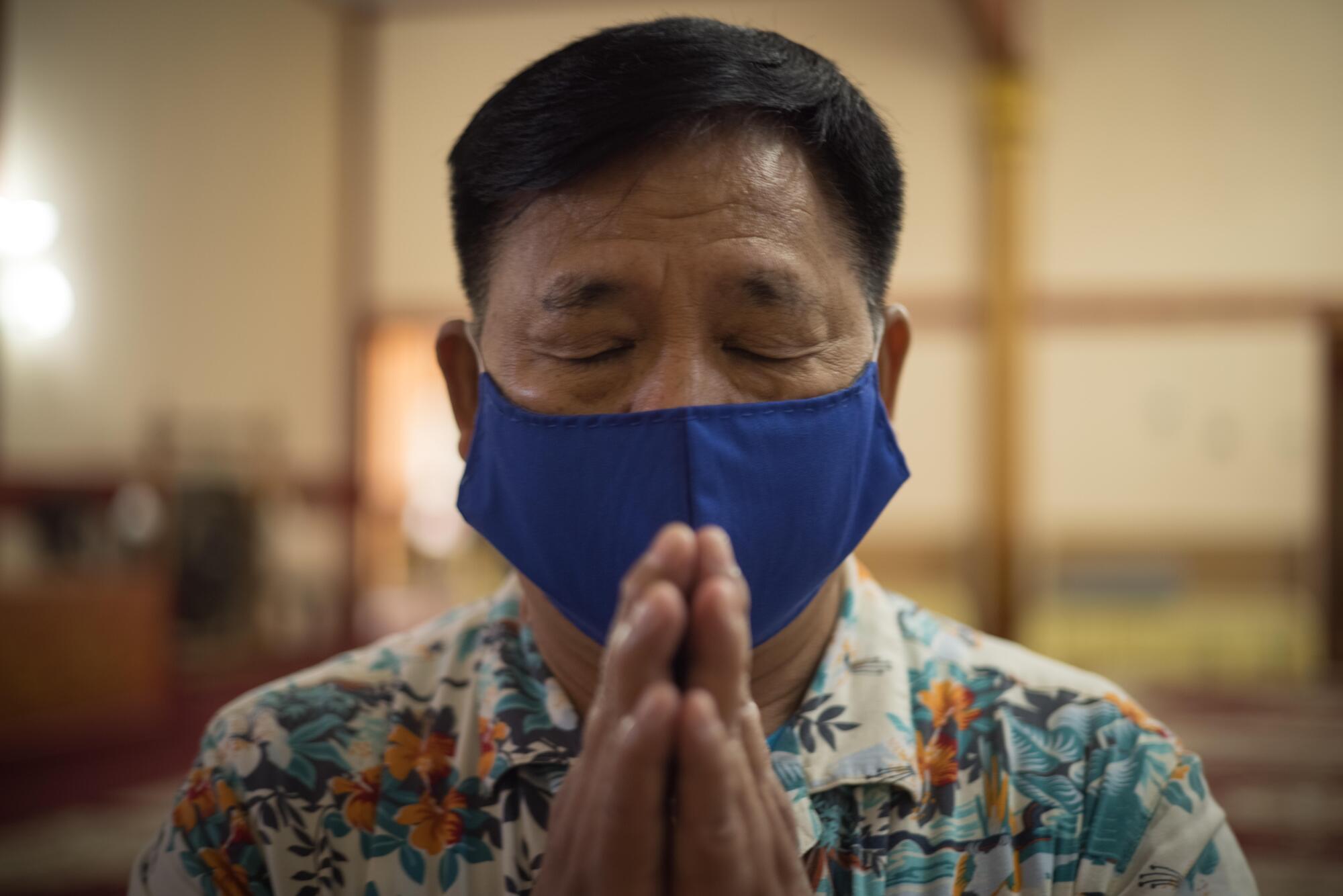 Torm Nompraseurt prays at Wat Lao Rattanaram Buddhist Temple in Richmond.