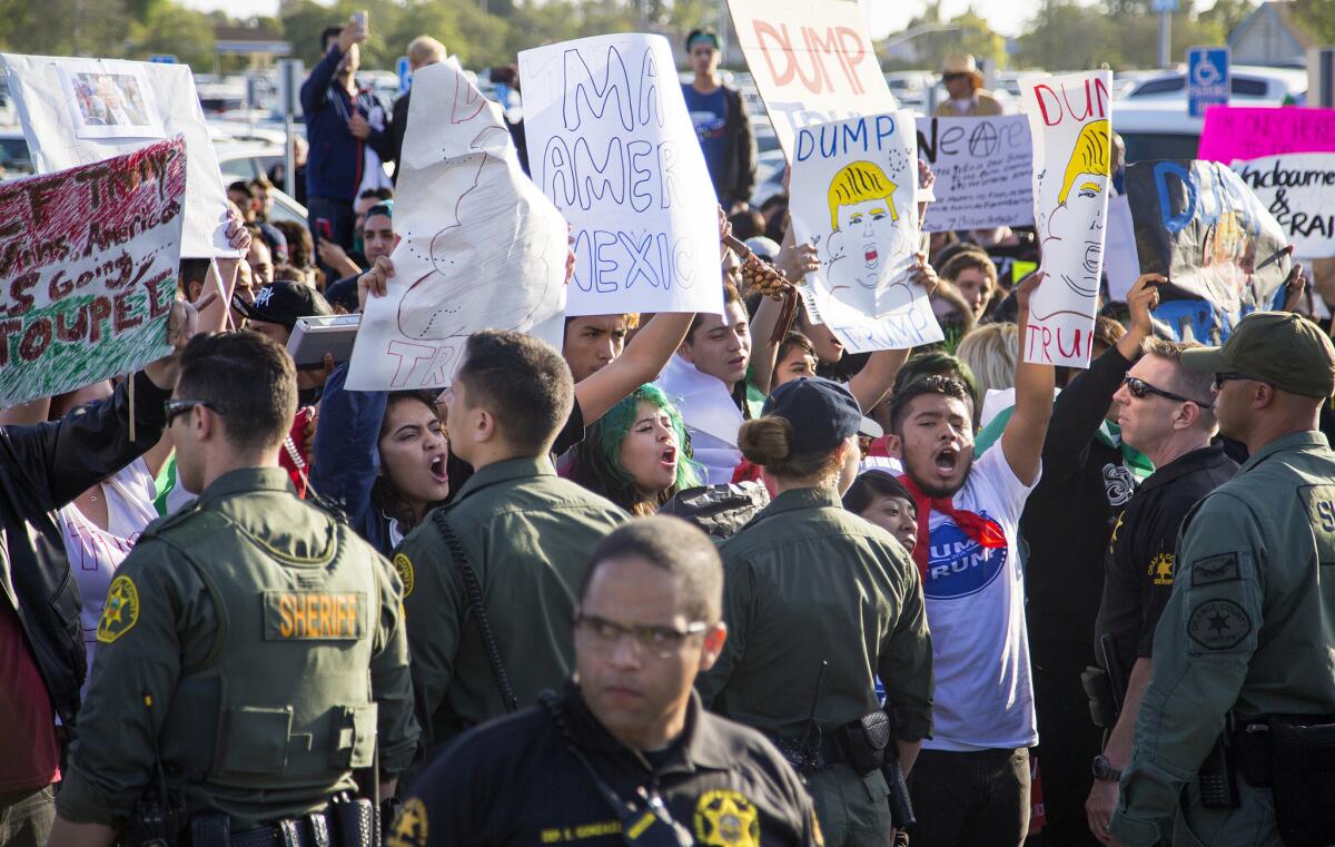 Orange County sheriff's deputies separate protesters from supporters at Donald Trump's rally in Costa Mesa.