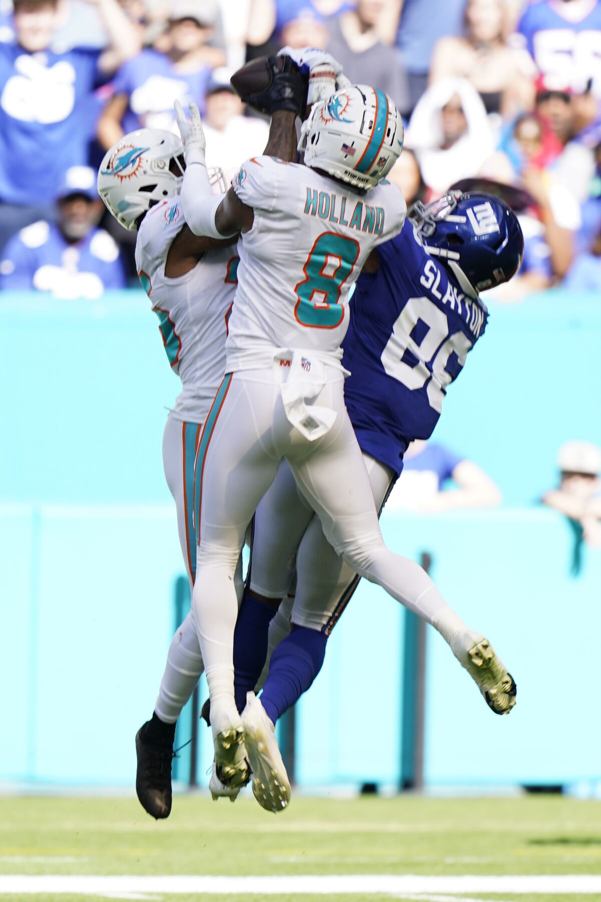 Miami Dolphins cornerback Xavien Howard (25) catches a pass intended for New York Giants tight end Evan Engram (88) near the end zone during the first half of an NFL football game, Sunday, Dec. 5, 2021, in Miami Gardens, Fla. Miami Dolphins free safety Jevon Holland (8) is center. (AP Photo/Wilfredo Lee)