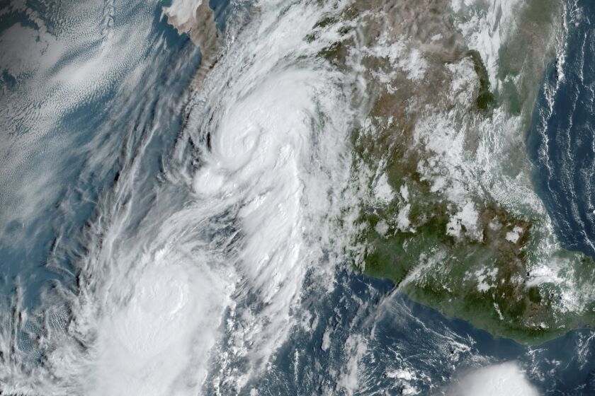 This GOES-16, GeoColor satellite image taken Friday, Sept. 20, 2019, at 14:50 UTC and provided by National Oceanic and Atmospheric Administration (NOAA), shows Hurricane Lorena, top center, followed by Tropical Storm Mario, near the southern tip of Mexico’s Baja California peninsula. (NOAA via AP)