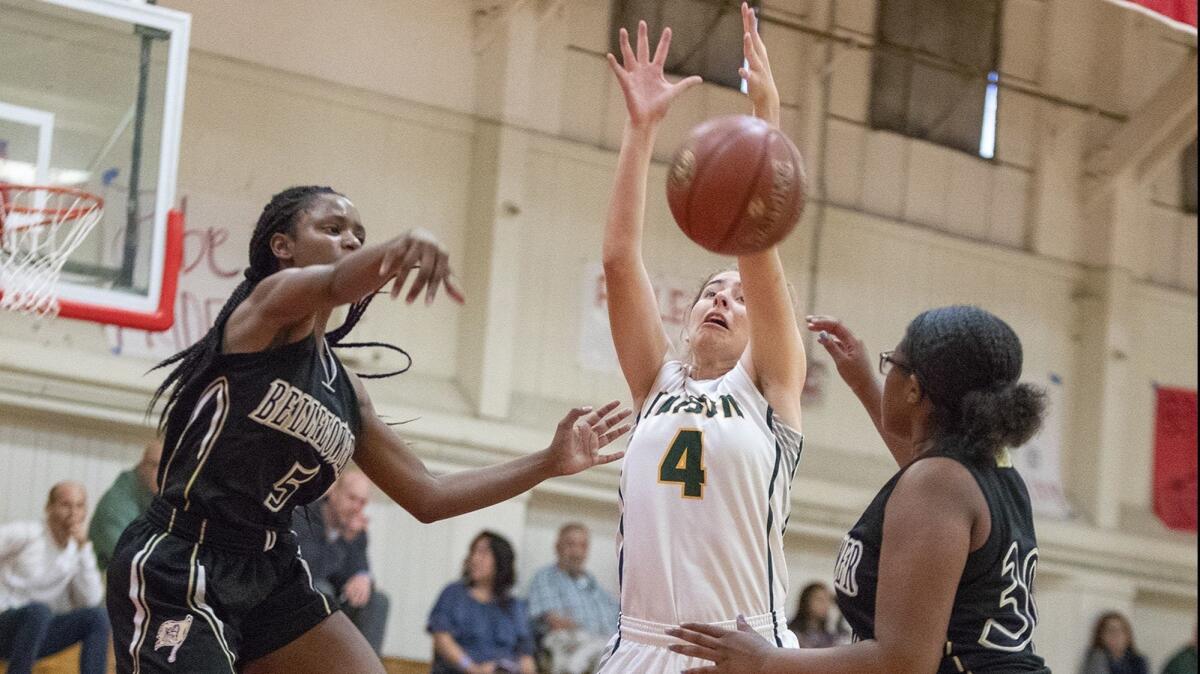 Edison High's Madison Copeland, pictured between two Bellflower players on Nov. 30, helped the Chargers beat Newport Harbor 43-30 on Tuesday.