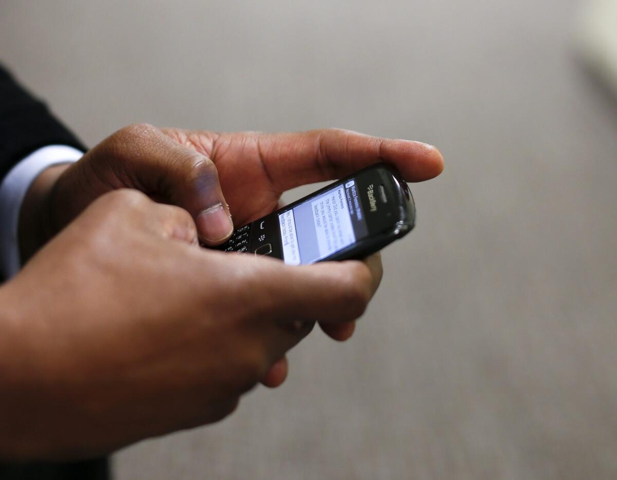 A man uses his Blackberry mobile device to write a text message in Atlanta in 2014. Unwanted calls and texts are the top consumer complaint to the Federal Communications Commission. The agency received 215,000 such complaints last year.