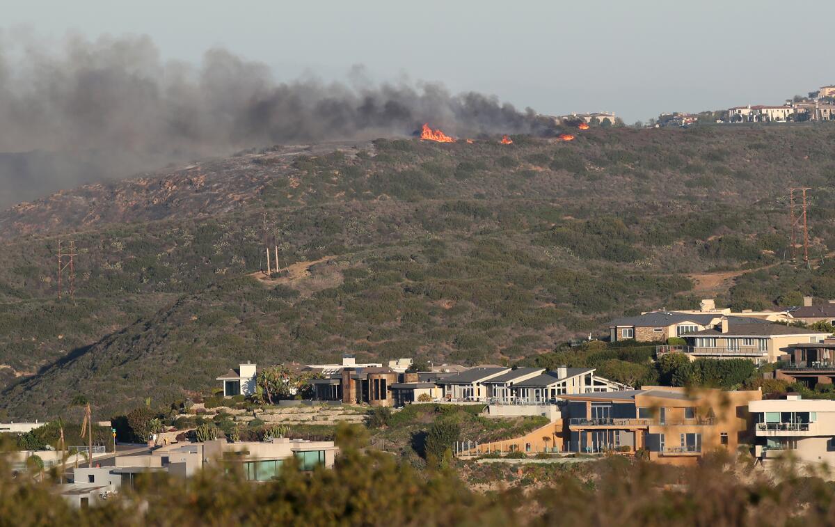 The crest of the Emerald fire burns to the top of a hillside in an unincorporated area behind Emerald Bay