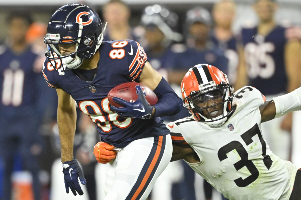 Chicago Bears wide receiver Dante Pettis (86) runs beside Cleveland Browns safety D'Anthony Bell (37) during an NFL preseason football game, Saturday, Aug. 27, 2022, in Cleveland. The Bears won 21-20. (AP Photo/David Richard)