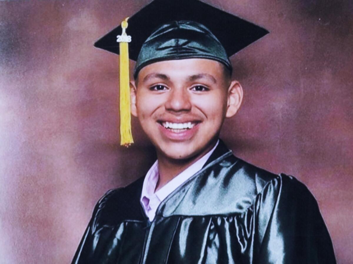 A young man in a graduation cap and gown