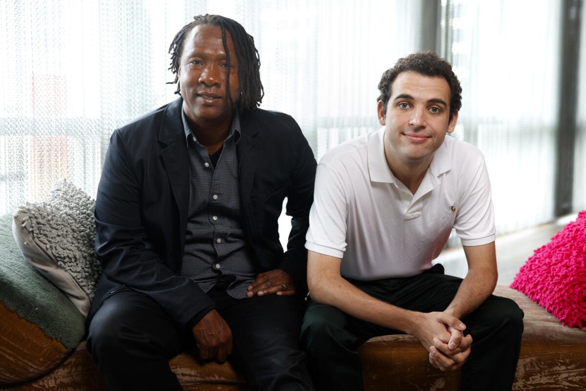 Academy Award-winning documentary director Roger Ross Williams, left, sits with Owen Suskind, an autistic young man who is the subject of Williams' documentary "Life, Animated."