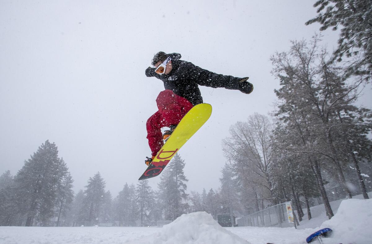 Snowboarder Malcolm Pope of Carlsbad catches air in Wrightwood, Calif., on Nov. 27. The Southland is facing another soggy holiday.