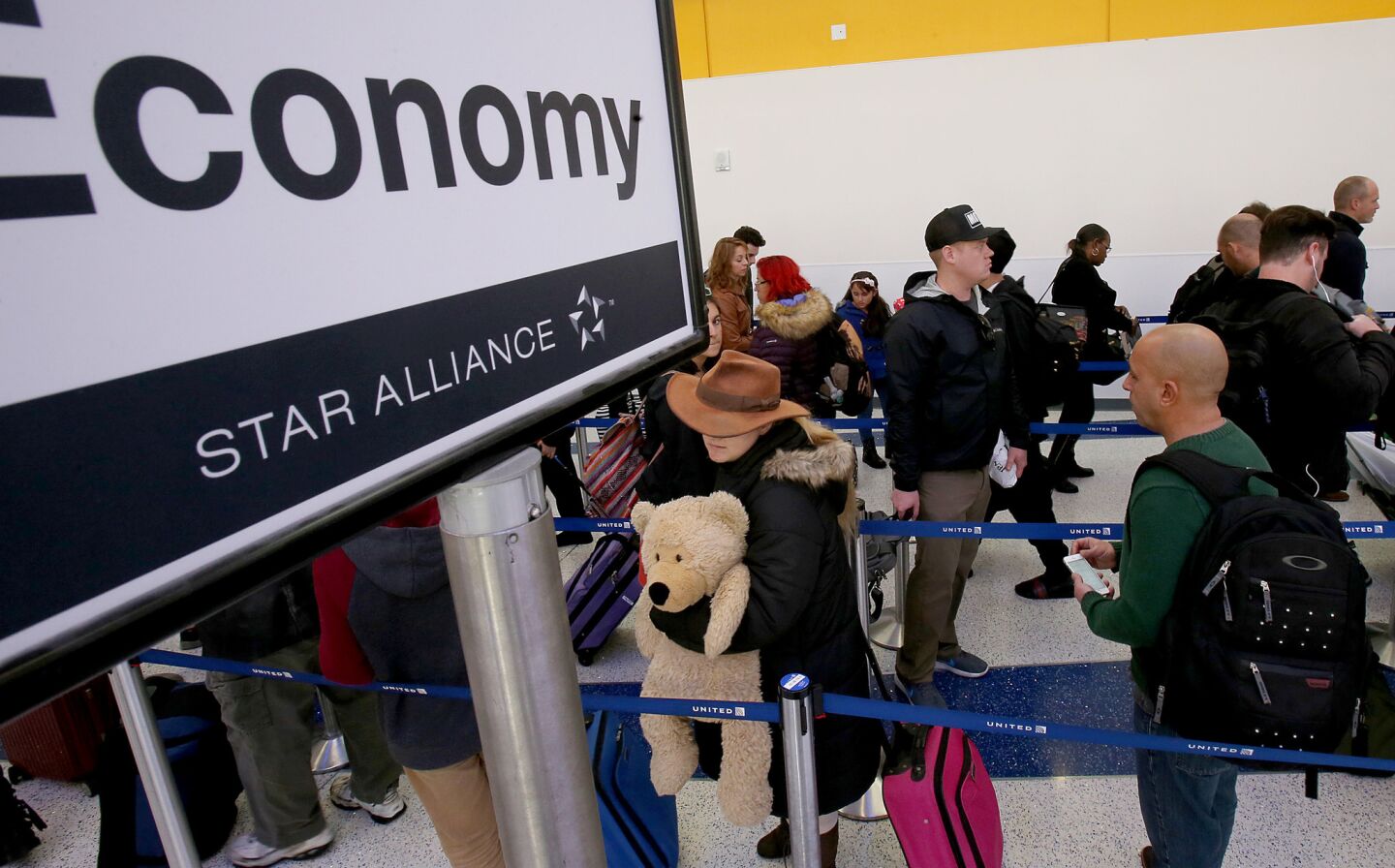 Holiday travelers line up for security screenings in Terminal 7 at LAX on Thursday.
