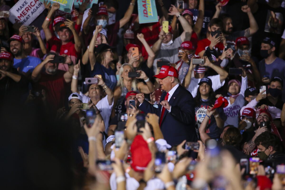 President Trump is surrounded by a crowd as he arrives at a campaign rally in Miami on Nov. 2.