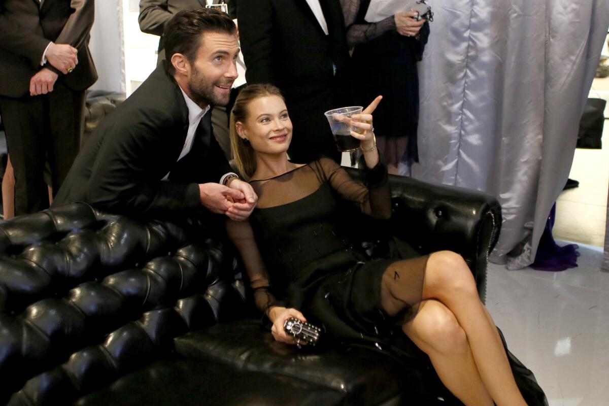 Adam Levine and Behati Prinsloo are having a good time in the green room at the 66th Primetime Emmy Awards in August.