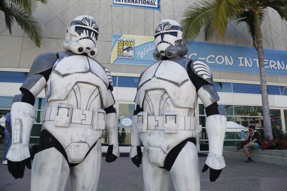 Two "Star Wars" fans dressed as stormtroopers at Comic-Con are shown outside the San Diego Convention Center.