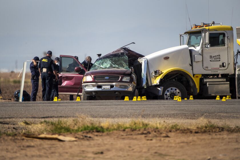 HOLTVILLE, CA - MARCH 2, 2021: CHP MAIT investigate the scene where an SUV was carrying 25 people collided with a semi-truck killing 13 on Highway 115 near the Mexican border on March 2, 2021 in Holtville, California. All the back seats had beens stripped form the vehicle. The passengers in the SUV ranged in age form 15-53.(Gina Ferazzi / Los Angeles Times)