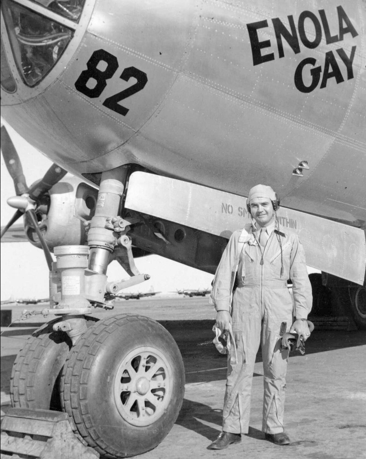 Col. Paul W. Tibbets stands beside the B–29 Superfortress bomber the Enola Gay in 1945 in an unknown location. He piloted the flight that dropped the atomic bomb on Hiroshima on Aug. 6, 1945. (Associated Press)