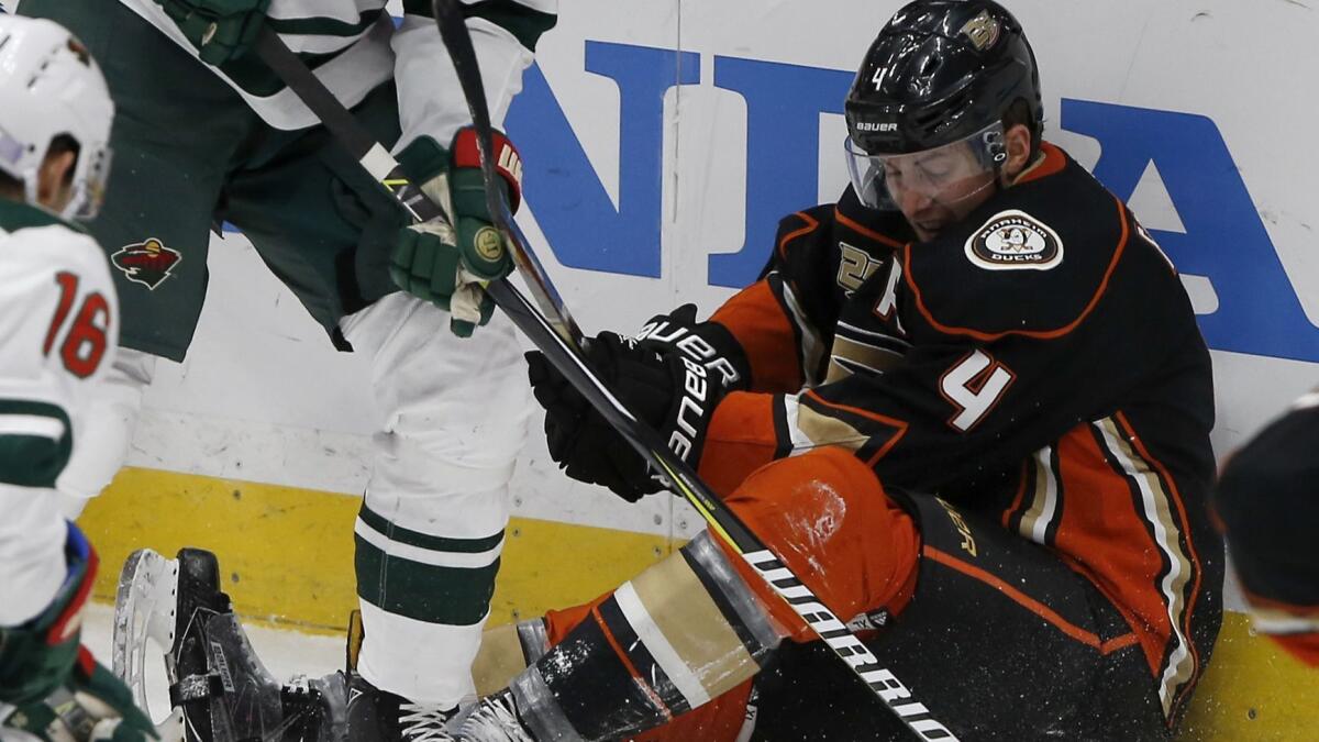 Ducks defenseman Cam Fowler fights for the puck against the Minnesota Wild during the third period on Friday.
