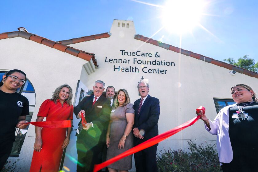 San Marcos, CA - August 11: The ceremonial ribbon gets cut at the Grand Opening event of the new TrueCare & Lennar Foundation Health Center at Casa de Amparo. I.D.'s of 5 principals in the middle who were also event guest speakers, LtoR: San Marcos Mayor Rebecca Jones, Casa de Amparo CEO Michael Barnett (with scissors), Lennar San Diego County Division President Ryan Green, TrueCare President and CEO Michelle Gonzalez, and San Diego County Supervisor District 5 Jim Desmond. (Charlie Neuman / For The San Diego Union-Tribune)