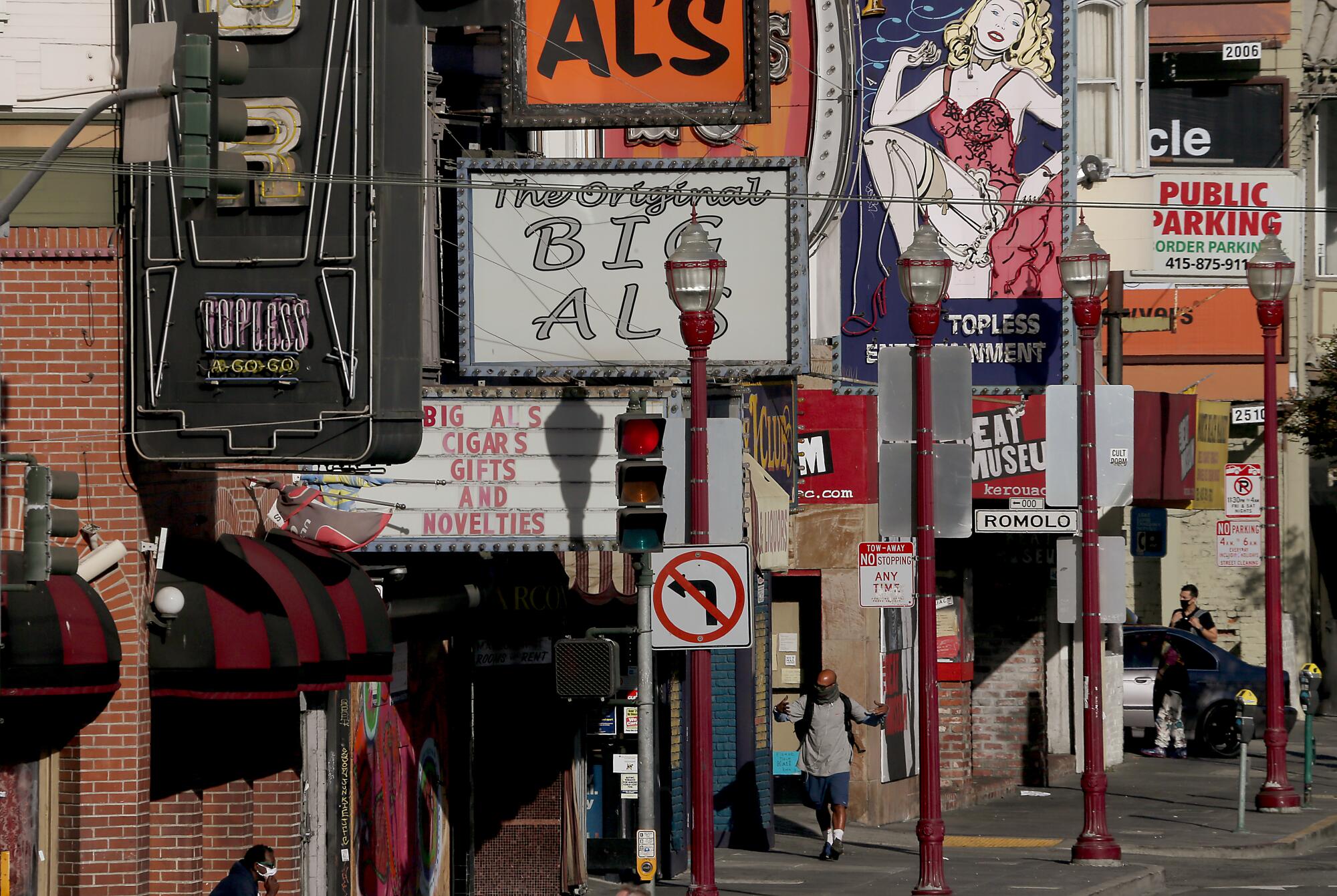 Pedestrians wear masks in the North Beach neighborood of San Francisco.