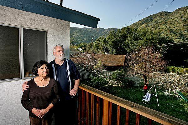John and Martha Jansen enjoy the views of the San Gabriel Mountains from the second-floor deck of their Duarte home. The couple are worried the proposed mining operation will compromise children's health and damage wildlife.