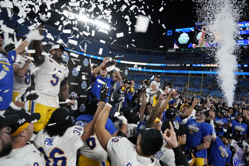 Pittsburgh head coach Pat Narduzzi celebrates with the trophy after their win against Wake Forest in the Atlantic Coast Conference championship NCAA college football game Saturday, Dec. 4, 2021, in Charlotte, N.C. (AP Photo/Chris Carlson)