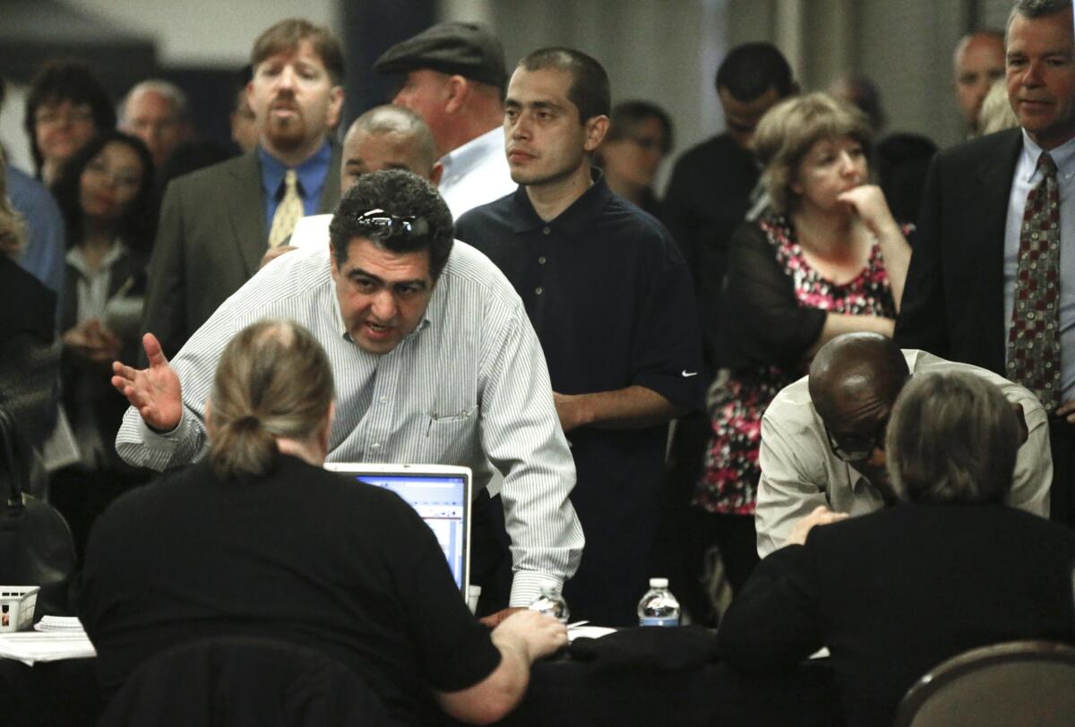 A report released Tuesday says FBI criminal background checks are often inaccurate and hurt job prospects for hundred of thousands. Above, a job fair in Anaheim in March.
