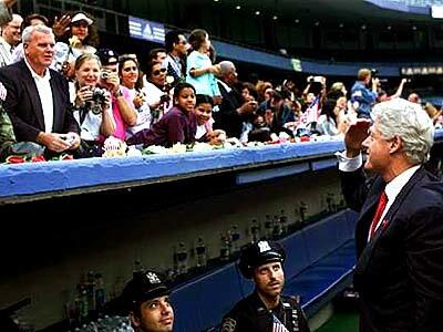 Former president Bill Clinton salutes the crowd at Yankee Stadium