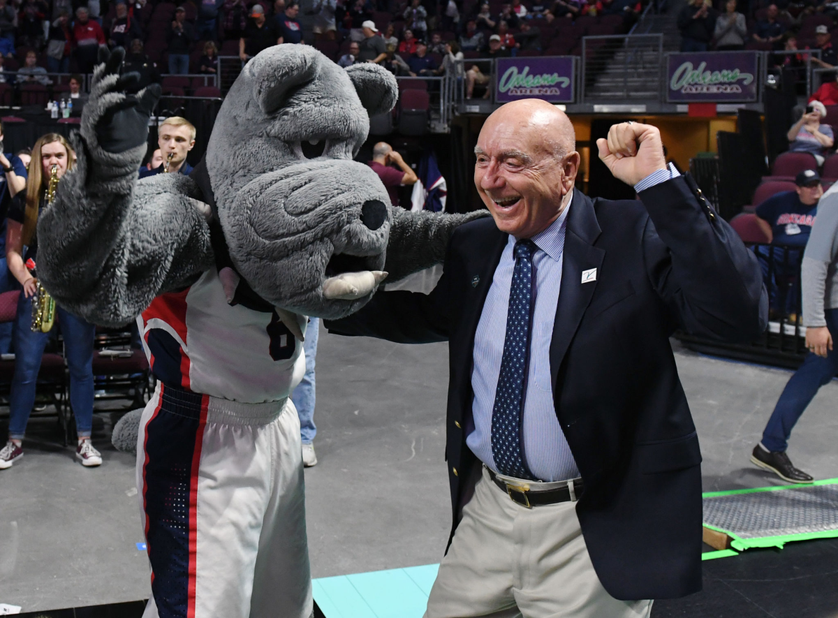 ESPN broadcaster Dick Vitale dances with the Gonzaga Bulldogs mascot before a game against Saint Mary's.
