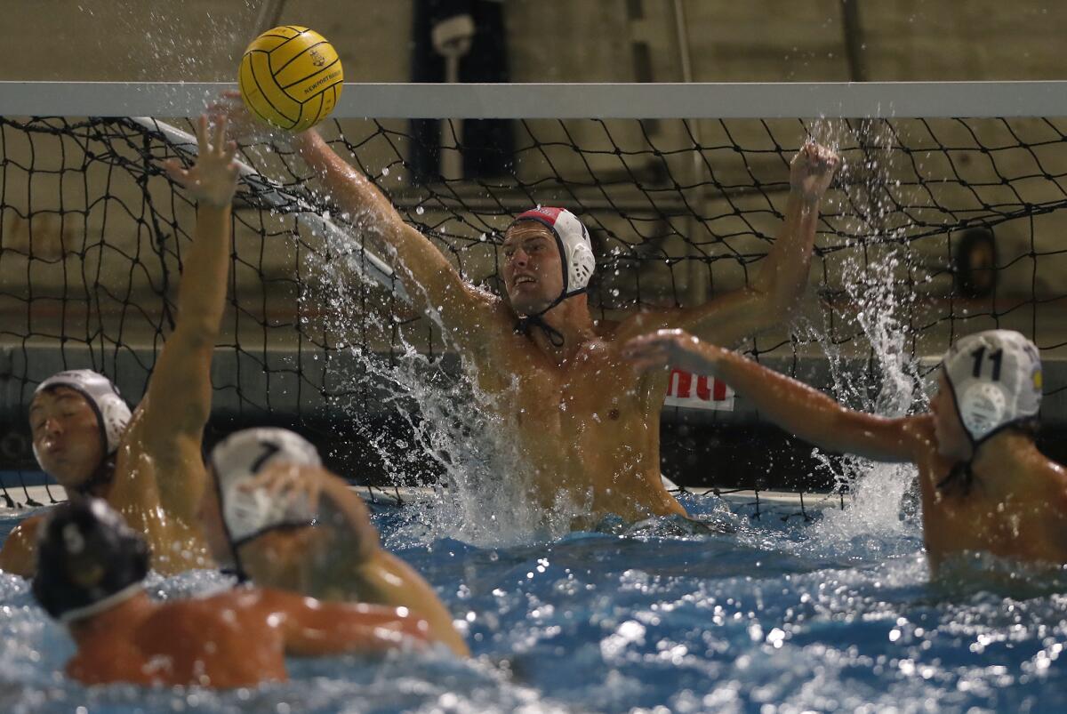 Newport Harbor goalkeeper Blake Jackson blocks a shot by Huntington Beach during the first half of a Surf League match in Newport Beach on Wednesday.