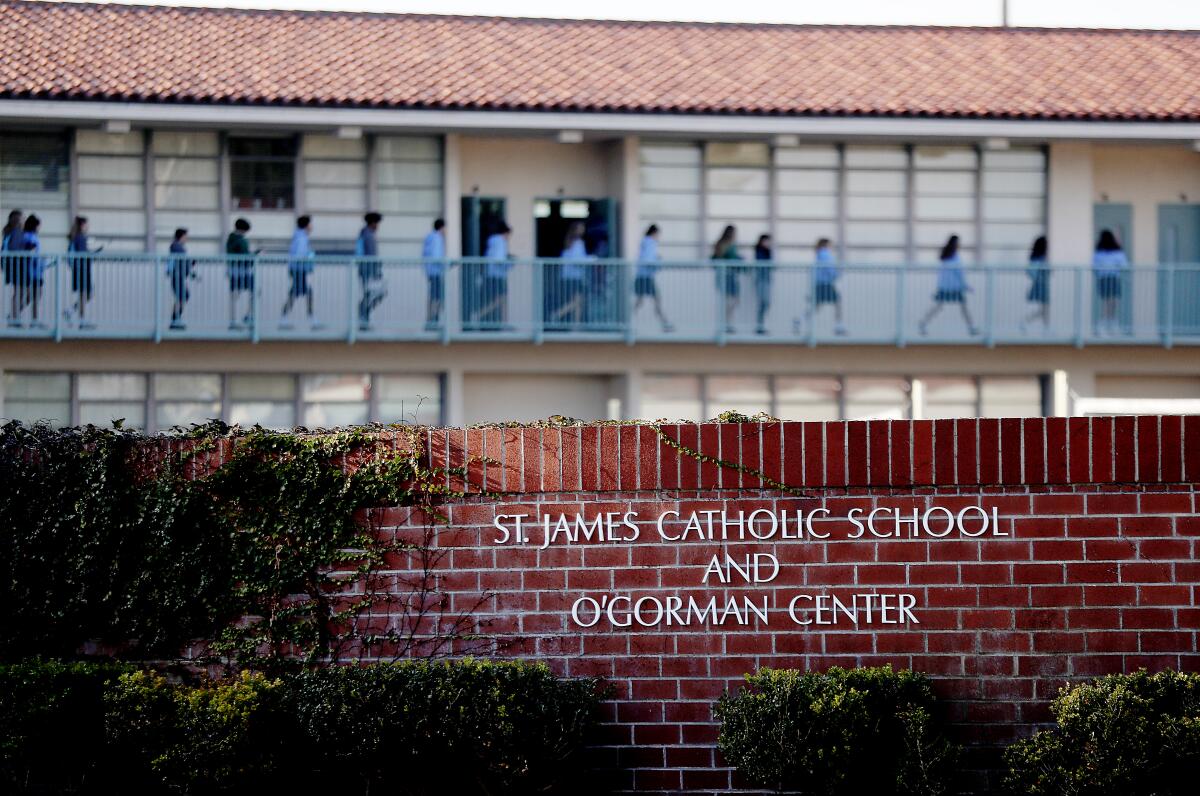 A line of children outside classrooms at St. James Catholic School in Torrance.