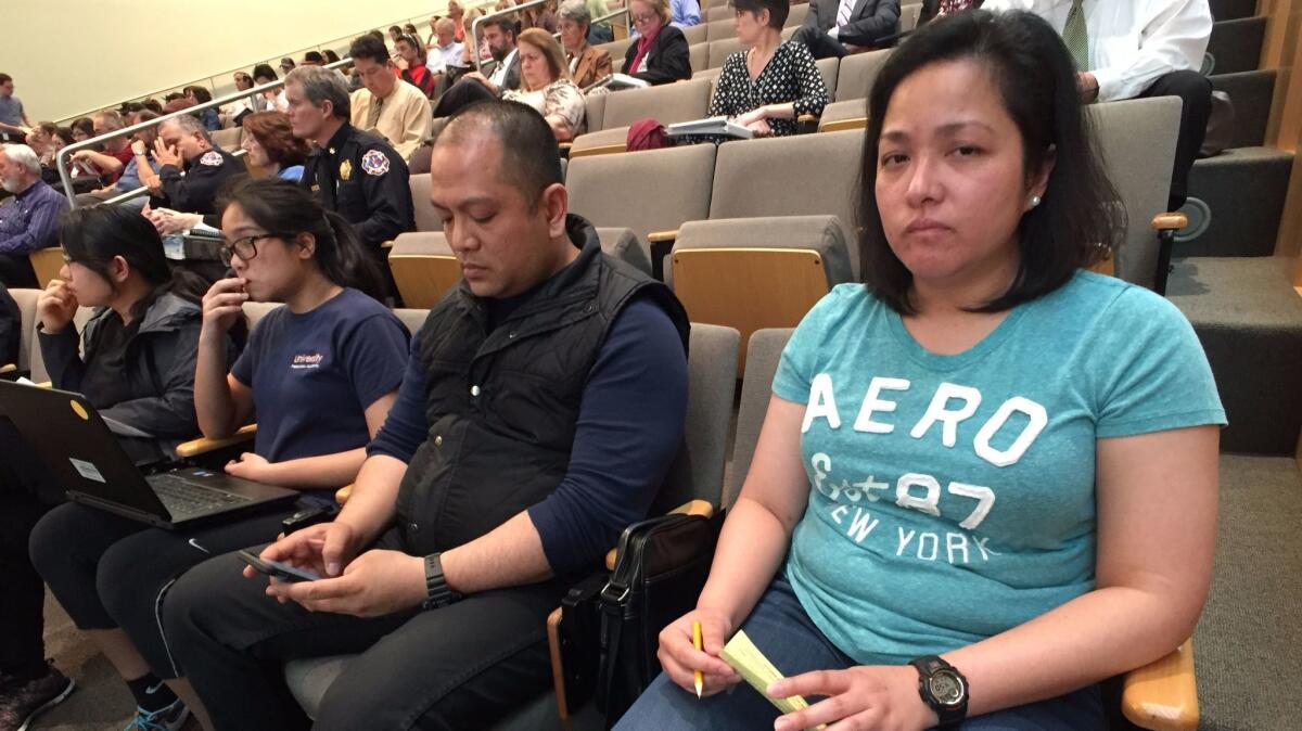 Elvie Cledoro, with her husband, Ben Cambare, and daughter Aiya Cledoro, wait to speak at a special meeting of the San Jose City Council. She told city officials they are not doing enough to help those displaced by Coyote Creek flooding.