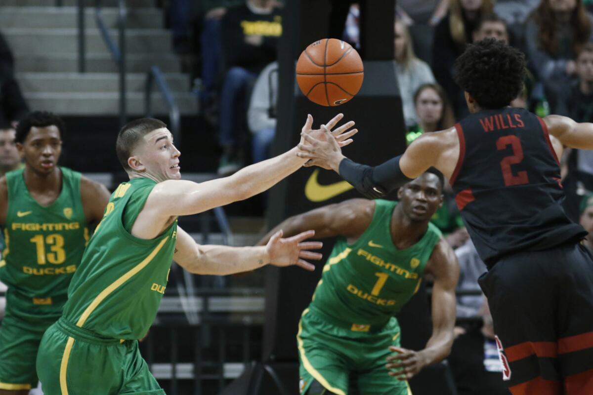 Oregon's Payton Pritchard, left, goes for the steal against Stanford's Bryce Wills on March 7, 2020, in Eugene, Ore.