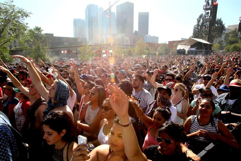 Music fans watch a performance by Cypress Hill at the Made In America Festival in downtown Los Angeles on Sunday.