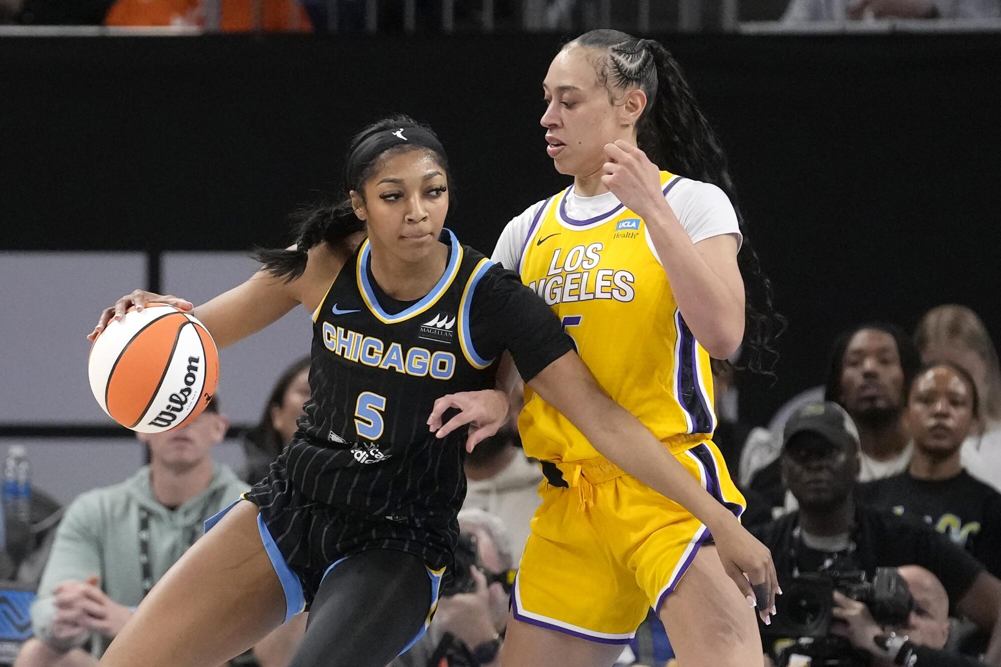 Chicago Sky's Angel Reese drives to the basket under pressure from the Sparks' Dearica Hamby.