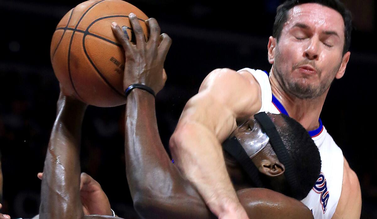 Clippers guard J.J. Redick fouls Magic guard Victor Oladipo as he tries to shoot in the second half.