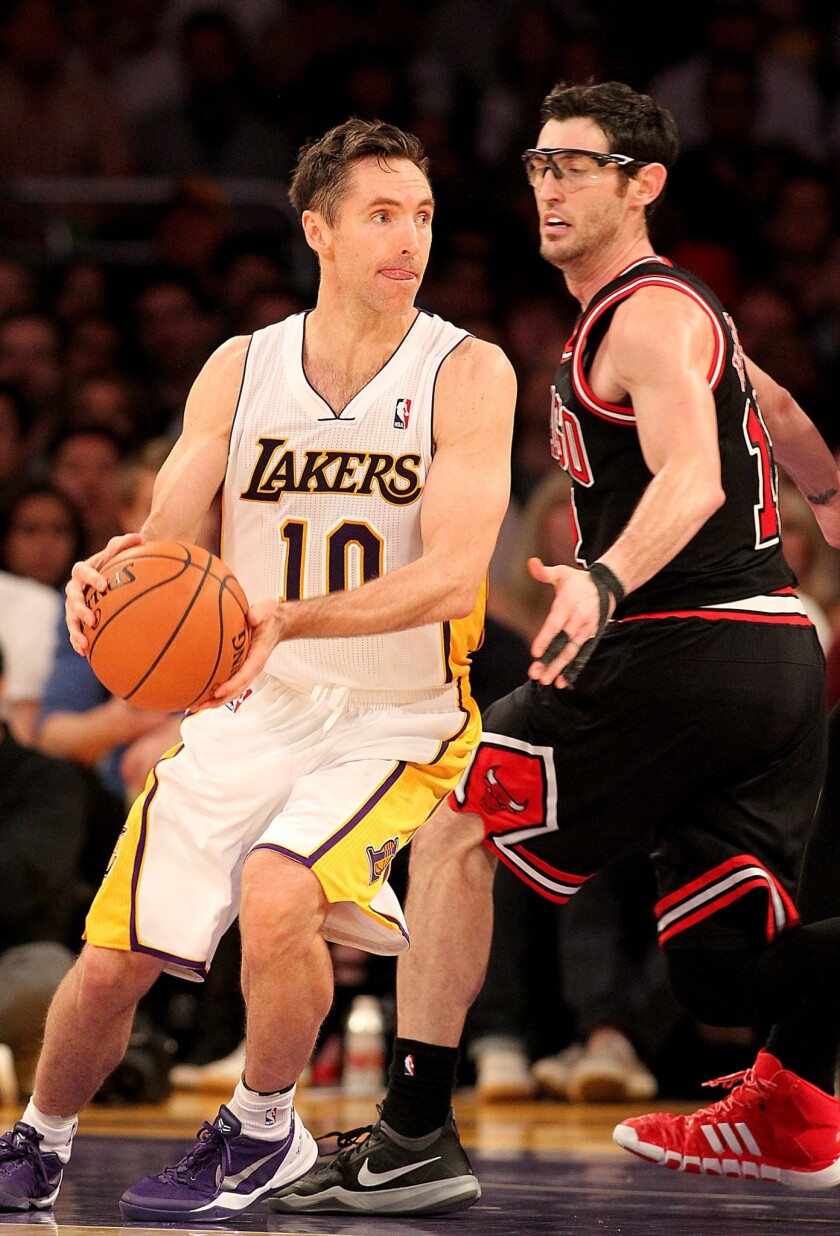 Lakers guard Steve Nash looks to pass around Chicago Bulls guard Kirk Hinrich during the Lakers' 92-86 loss at Staples Center.