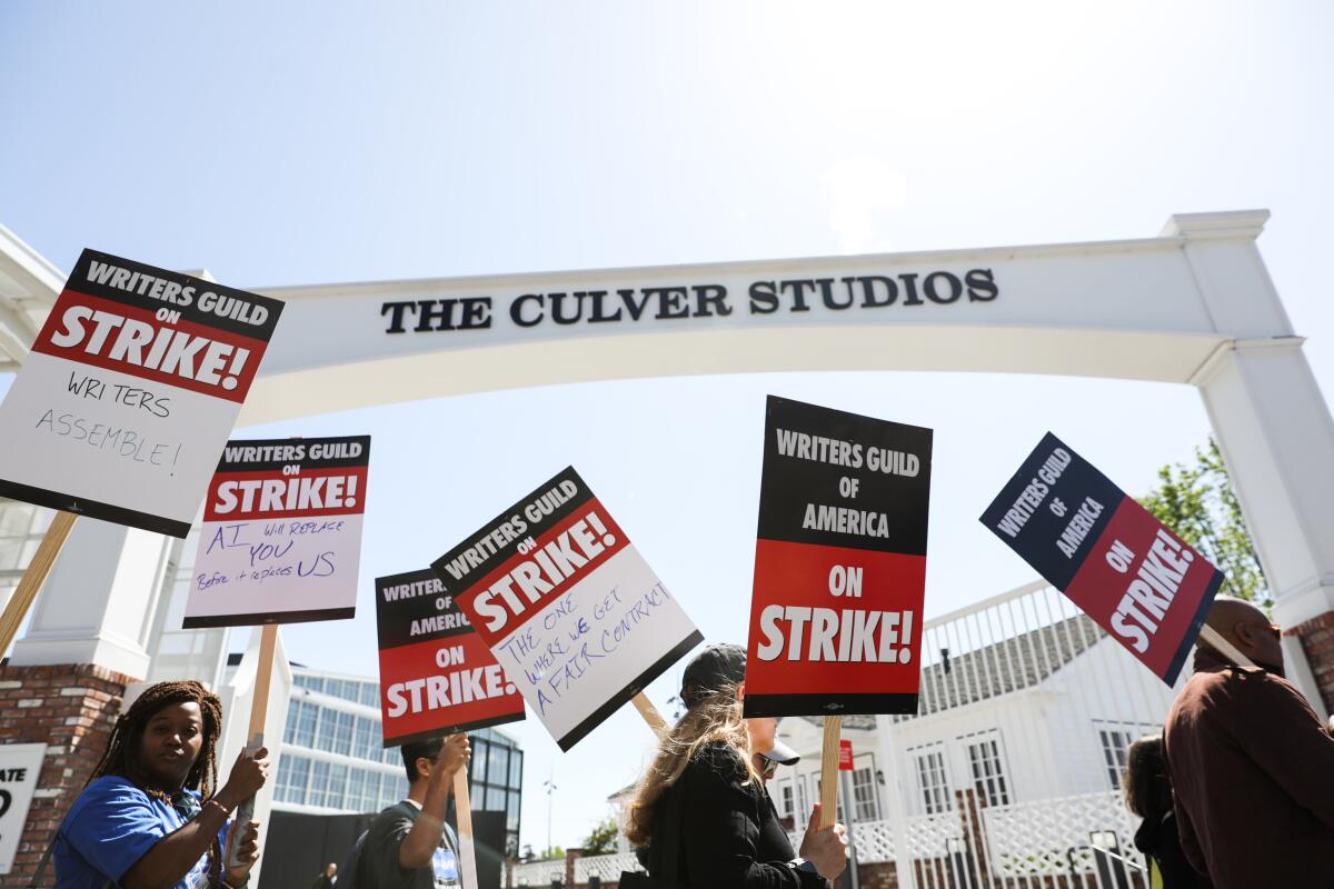 Writers Guild of America members walk the picket line on the first day of their strike in Culver City.