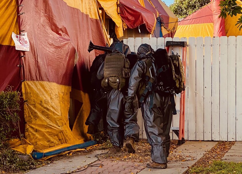 Los Angeles County sheriff's deputies enter a tented home in Whittier, where a man was found dead Tuesday.