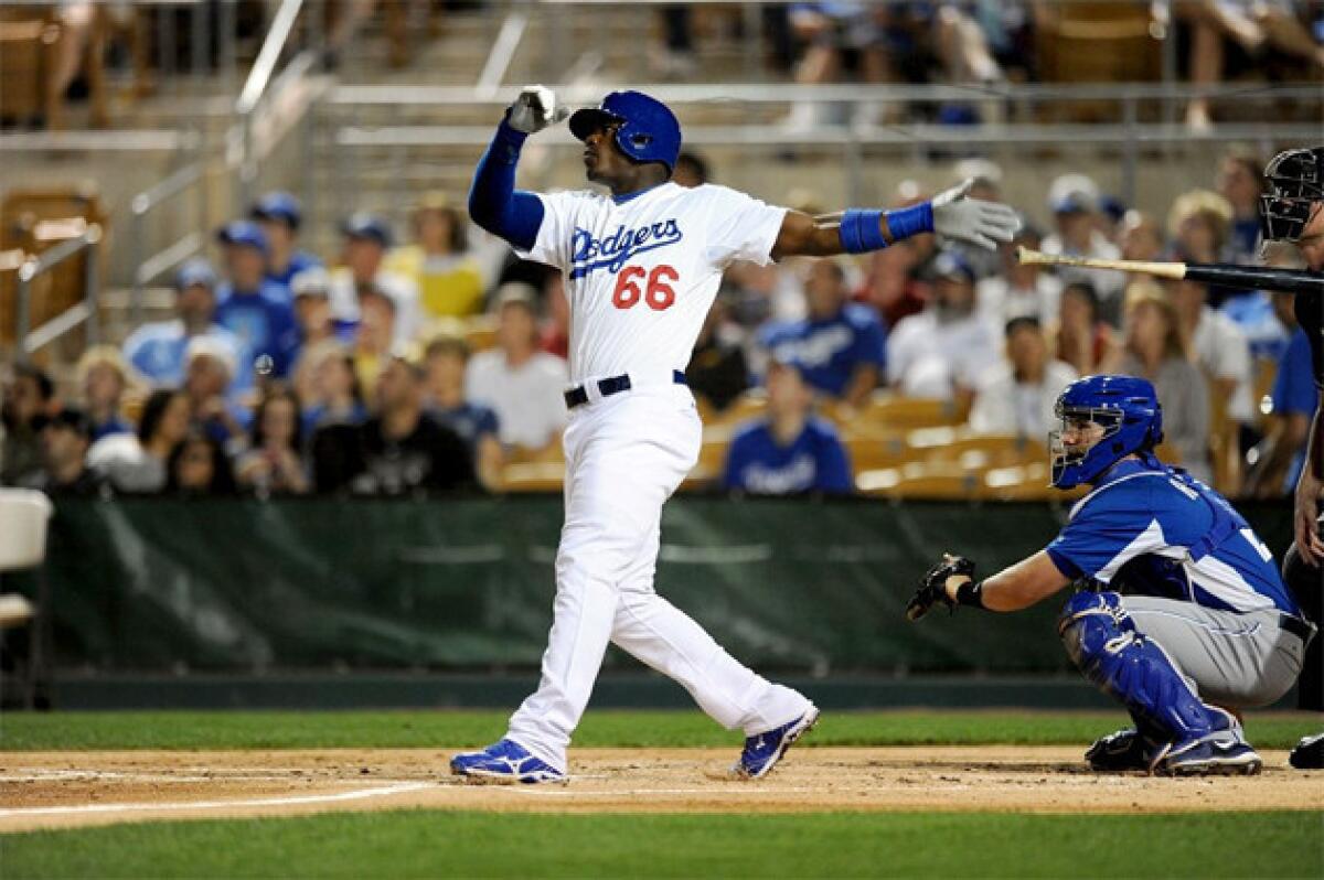 Dodgers outfielder Yasiel Puig belts a home run against the Kansas City Royals on March 15.