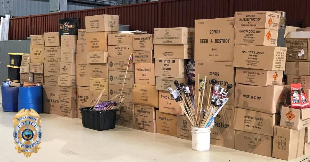 Several boxes with titles on them such as "Pyro Addicts" stacked up with fireworks in other containers in front of them.