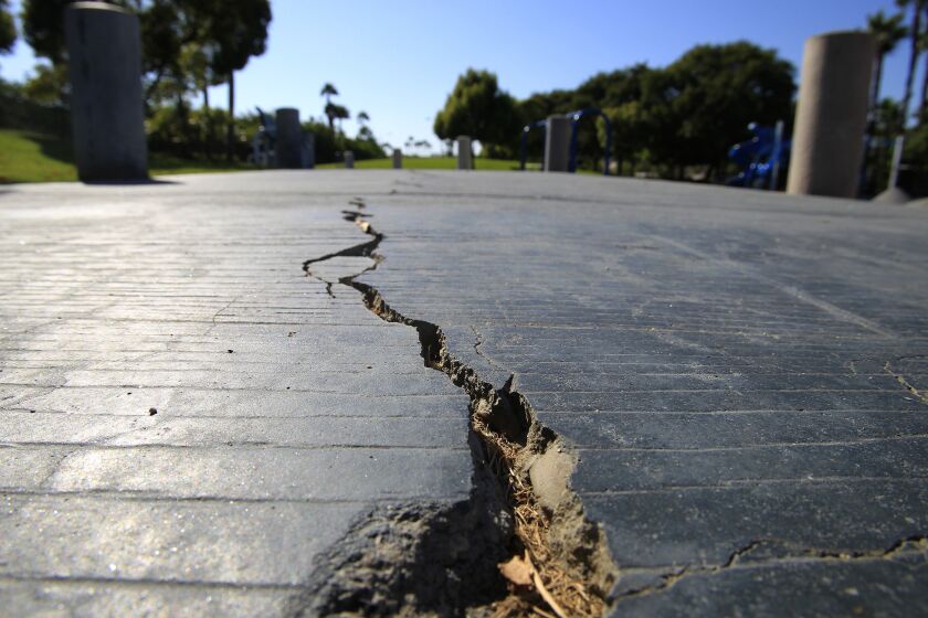 HUNTINGTON BEACH, CA--AUG. 21, 2014: A long crack splits the sidewalk at the Discovery Well Park in the SeaCliff area of Huntington Beach, located on top of the Newport-Inglewood fault, which is integrated into developments Thursday, Aug. 21, 2014. (Photo By Allen J. Schaben / Los Angeles Times)