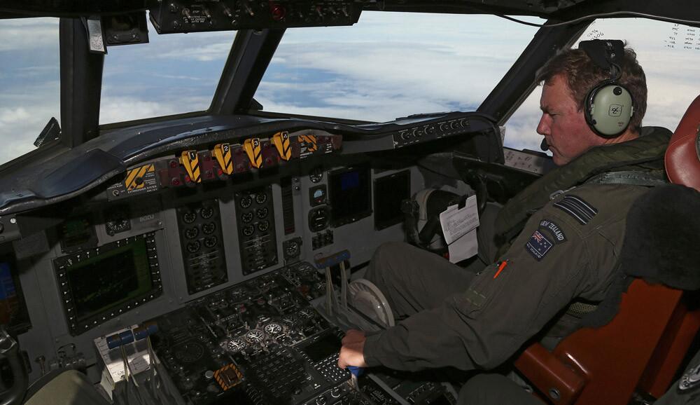 Royal New Zealand Air Force P3 Orion co-pilot Brett McKenzie flies the plane while searching for missing Malaysia Airlines flight MH370 over the Indian Ocean on March 31.