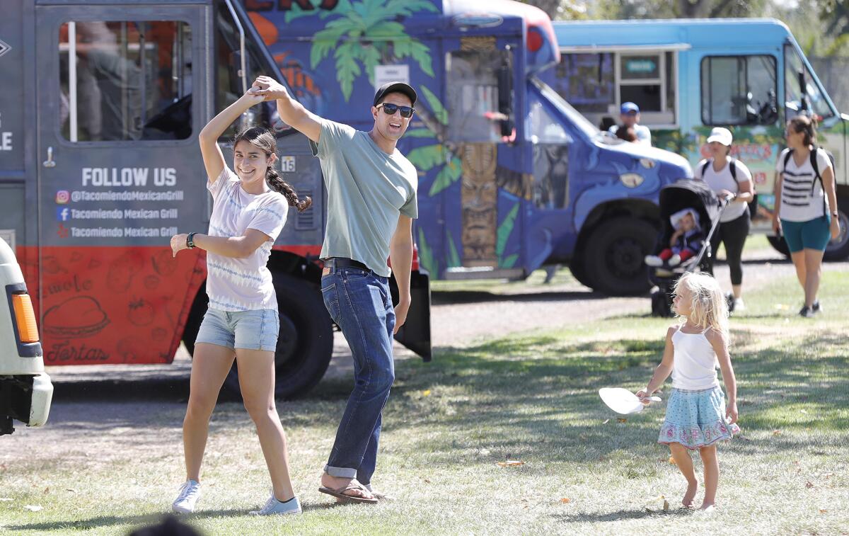 Gabriel and Isabell Vega dance in front of the food truck during the return of Costa Mesa's "Concerts in the Park."