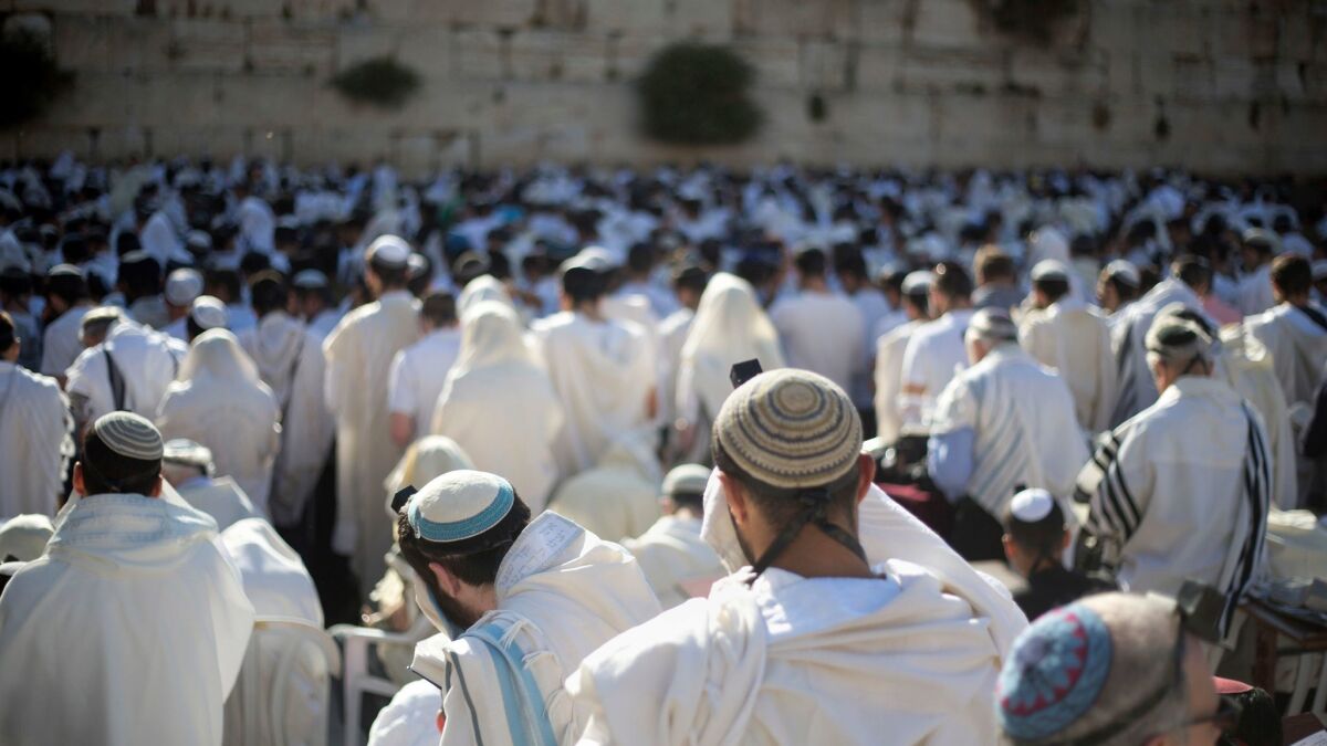 Jewish men pray at the Western Wall during Jerusalem Day celebrations on May 24.