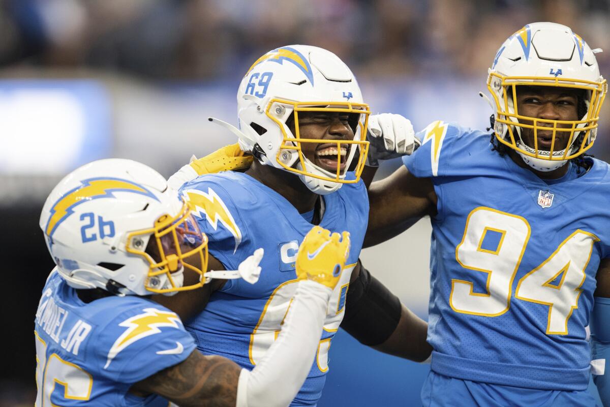 Chargers defensive tackle Sebastian Joseph-Day (69) celebrates with teammates after sacking Rams quarterback Baker Mayfield.