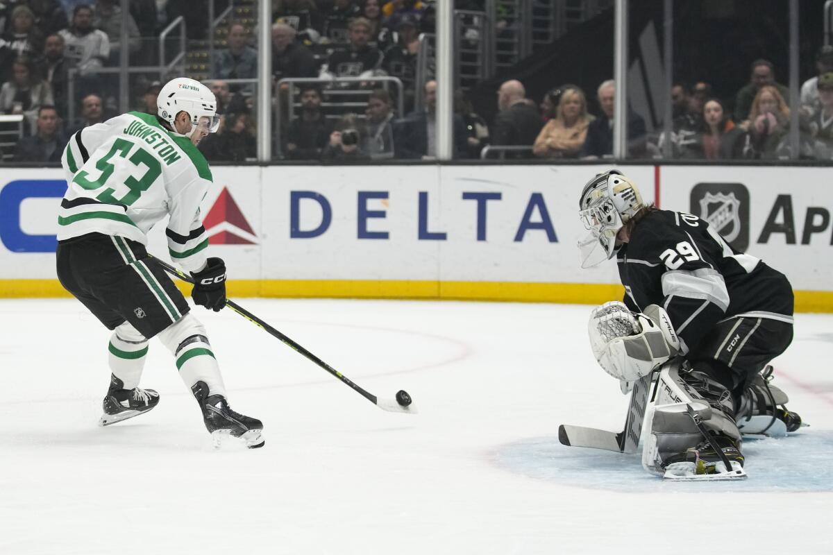 Dallas Stars center Wyatt Johnston backhands a shot against Kings goaltender Pheonix Copley.