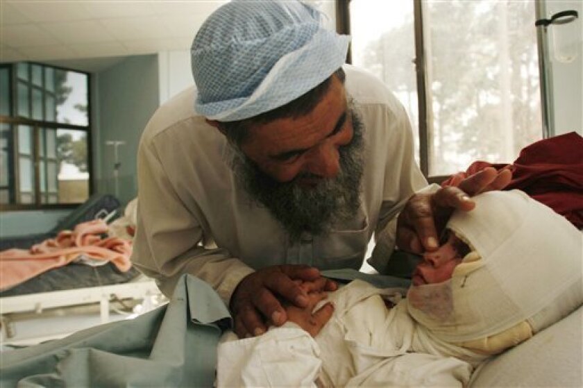 Haji Barkat Ullah speaks with her daugther Frishta 7, who was wounded in coalition airstrike on Monday night in Bala Baluk district of Farah province recovers in a hospital in Herat, Afghanistan, Saturday, May 9, 2009. A joint U.S.-Afghan investigation has found that civilians were killed during a battle in southern Afghanistan, but officials have not been able to determine how many.(AP Photo/Fraidoon Pooyaa)