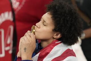 American Brittney Griner kisses her gold medal at Bercy Arena at the 2024 Summer Olympics Sunday.