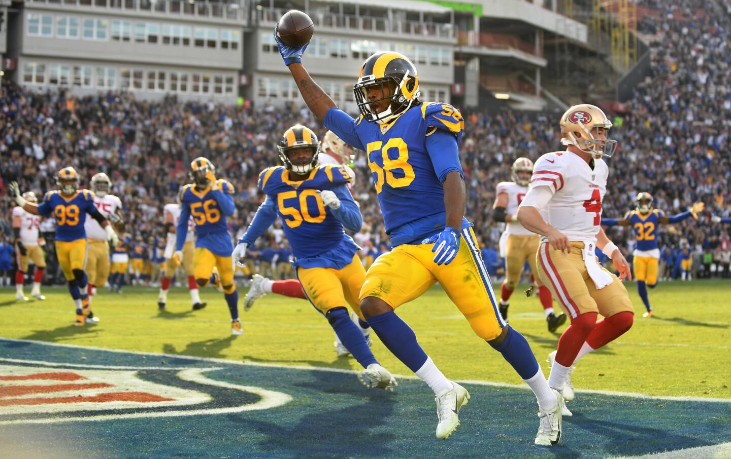 Rams linebacker Cory Littleton beats 49ers backup quarterback Nick Mullens (4) to the end zone while returning an interception for a touchdown last season.